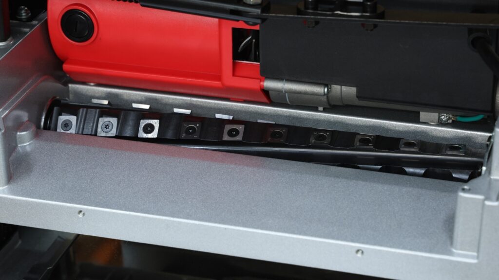 Close-up of the helical cutterhead inside the FindBuyTool FB131H planer, showing carbide insert knives