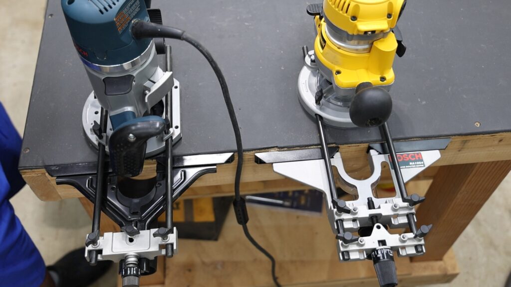 Bosch and DeWalt routers each fitted with opposite brand edge guides for compatibility testing.