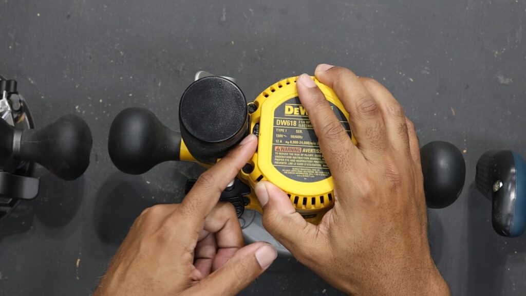 Close-up of DeWalt DW618PKB router’s variable speed control dial on the motor housing.