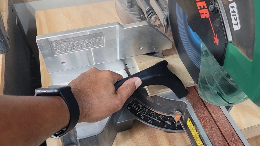 FastCap 10 million dollar stick holding small wood piece on miter saw