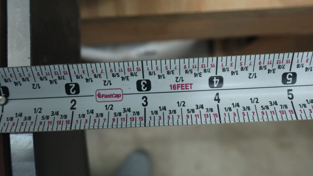 Close-up of FastCap tape measure with labeled fractional markings