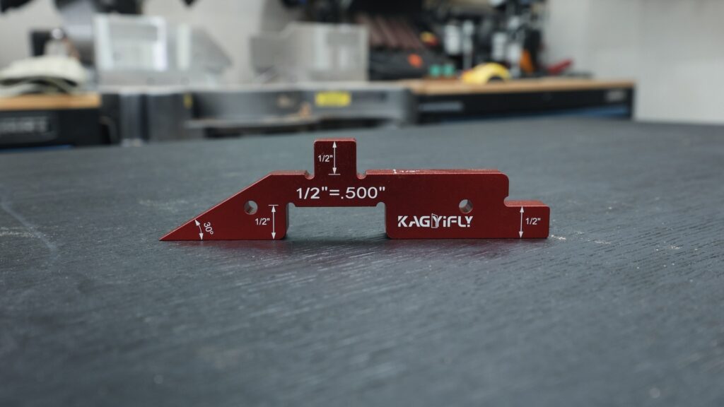 Red Kagyifly setup bar on table saw with measurement markings visible