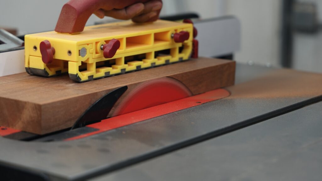 Milescraft GrabberPro push block guiding wood through table saw blade