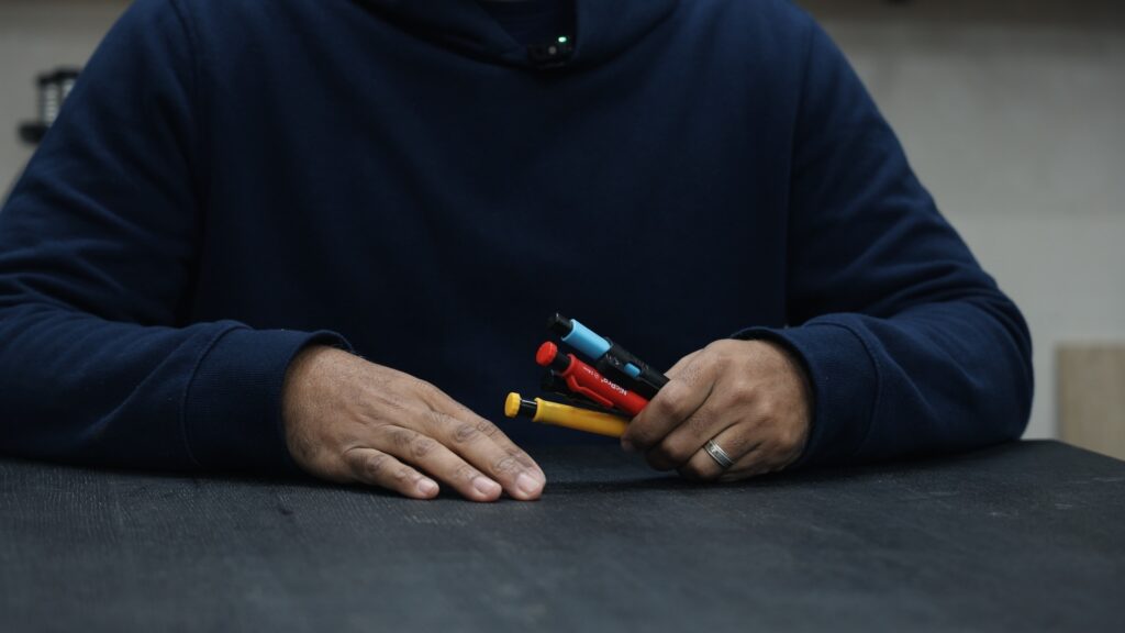 Four colored mechanical carpenter pencils with yellow red white and graphite leads