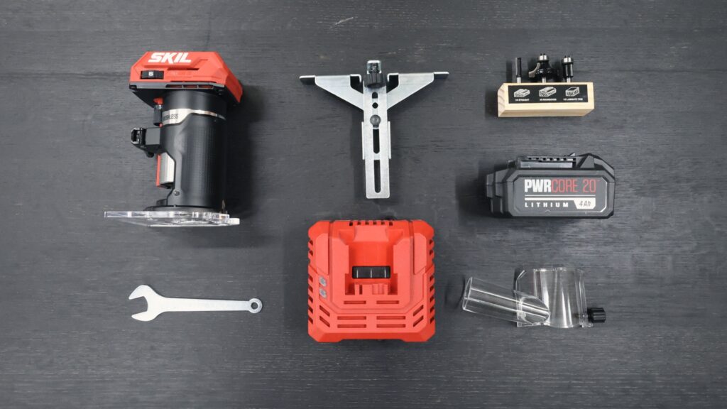 SKIL RT1430B kit contents with battery, charger, edge guide, bits, wrench, dust shroud