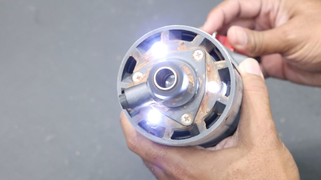 Bottom view of the SKIL router showing multiple LED lights around the collet area.