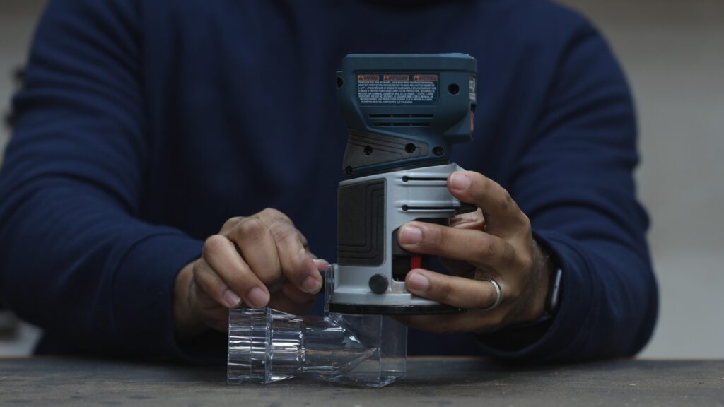 Bosch GKF18V-25 cordless trim router with edge profile dust chute installed