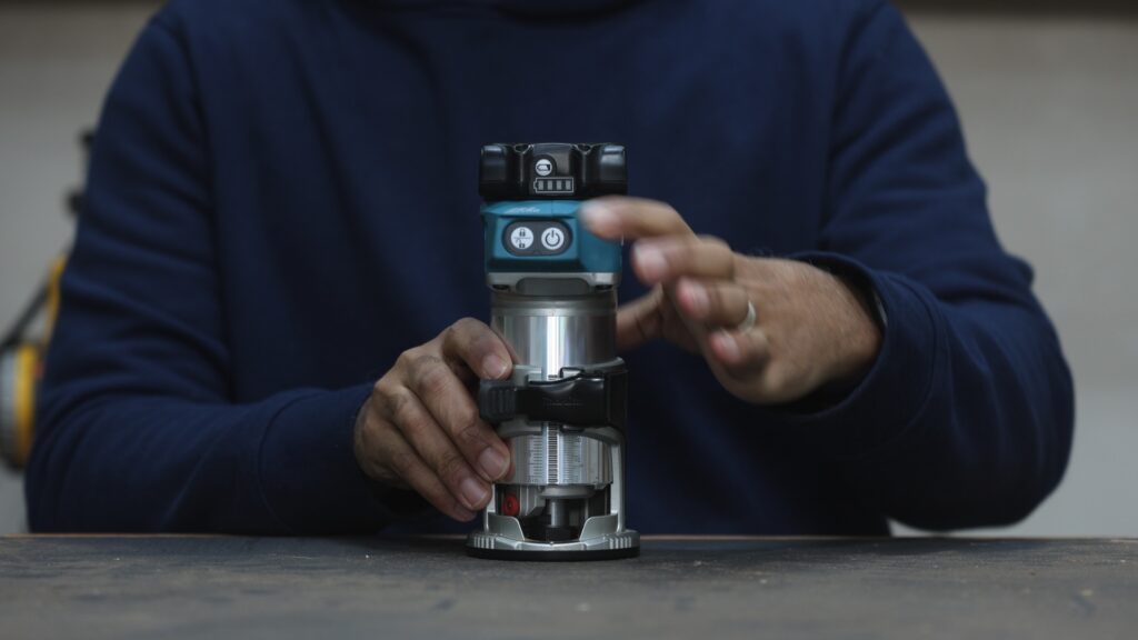 Primary and secondary power buttons on the Makita XTR01Z trim router