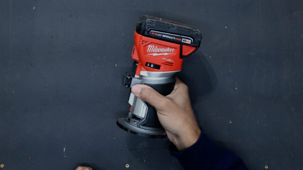 Milwaukee 2723-20 M18 Fuel cordless trim router held in one hand
