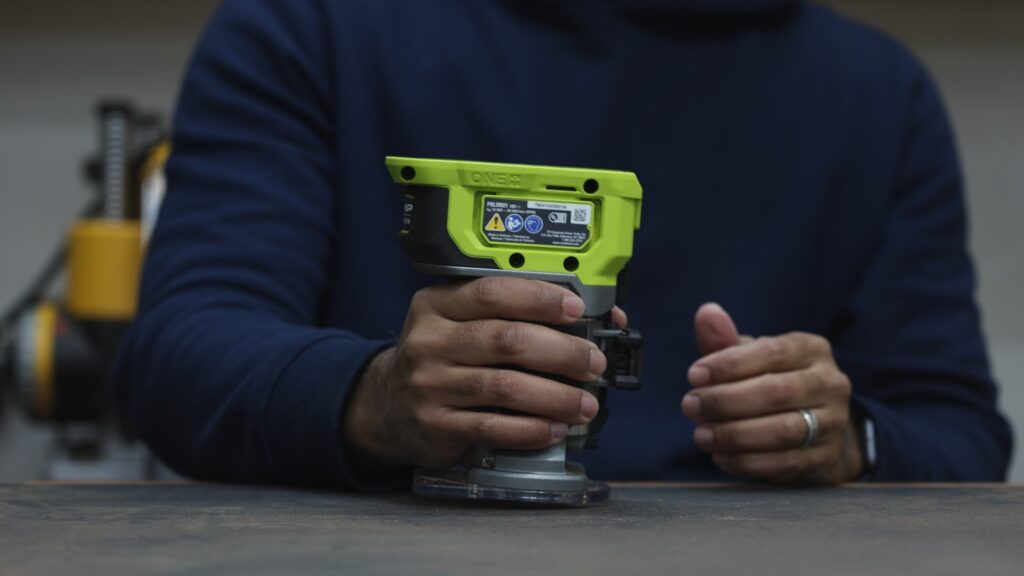 Ryobi ONE+ HP cordless trim router held in hand showing grip and balance